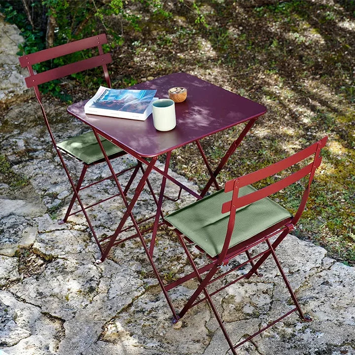 Powder-coated Fermob Bistro chairs in a Provencal courtyard