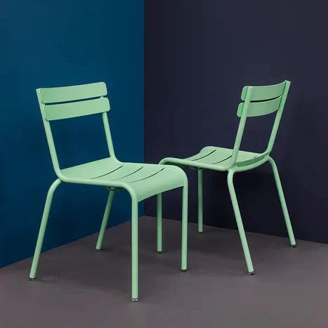 Fermob Luxembourg Side Chair in Opaline Green, a stackable powder-coated aluminium garden chair with curved slats.