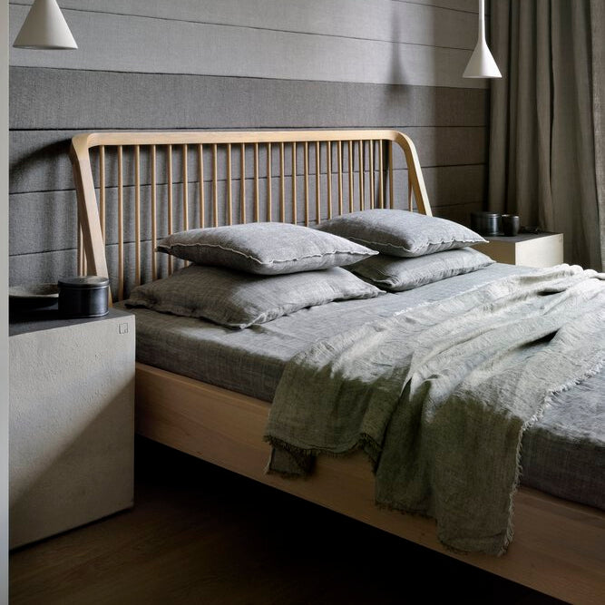 Ethnicraft Oak Spindle Bed in oak styled in an interior setting