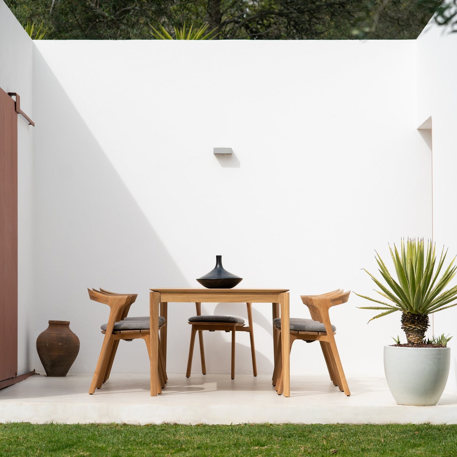 Ethnicraft Bok Outdoor Dining Chair Cushion styled in a dining room