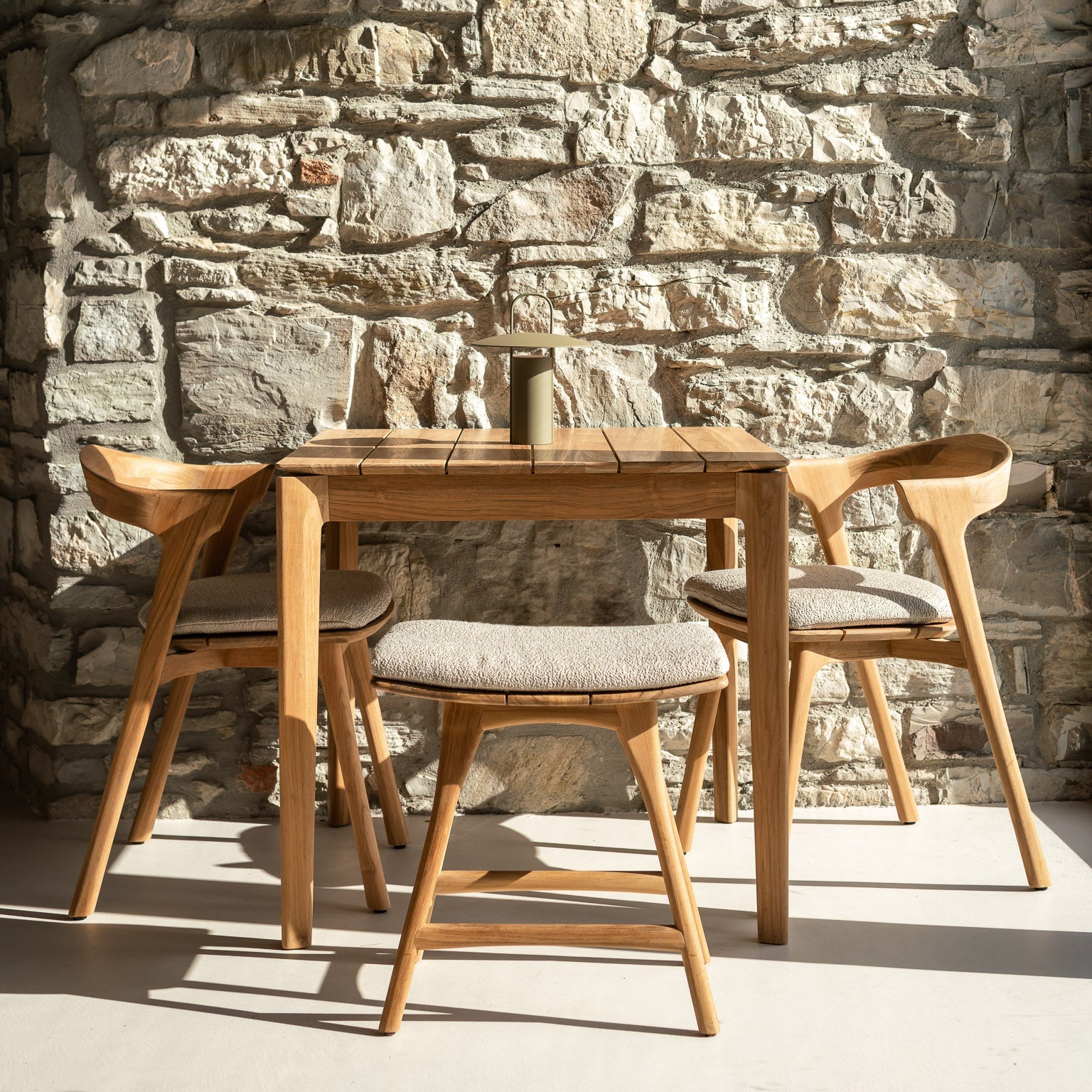 Ethnicraft Osso outdoor stool styled in a dining room