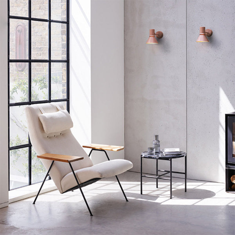 Anglepoise Type 80 wall lights in Rose Pink and Pistachio Green beside a lounge chair