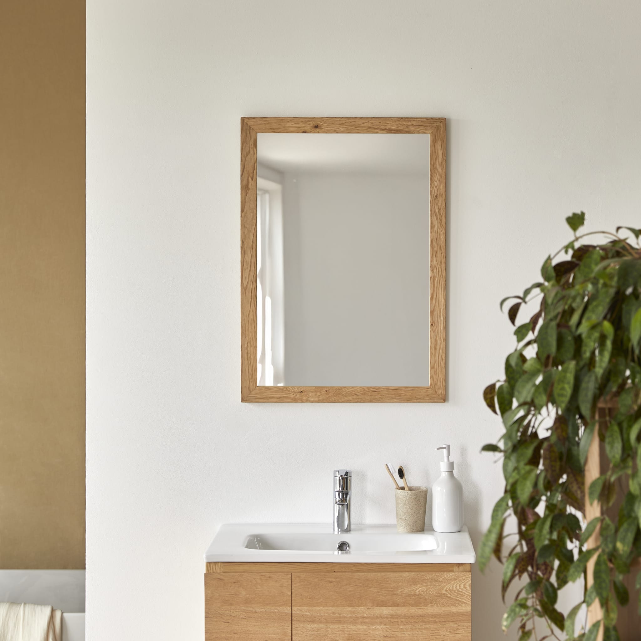 Serena solid oak mirror, front view on a white wall