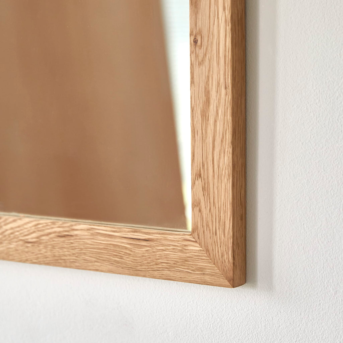 Serena oak mirror hung above a bathroom washstand