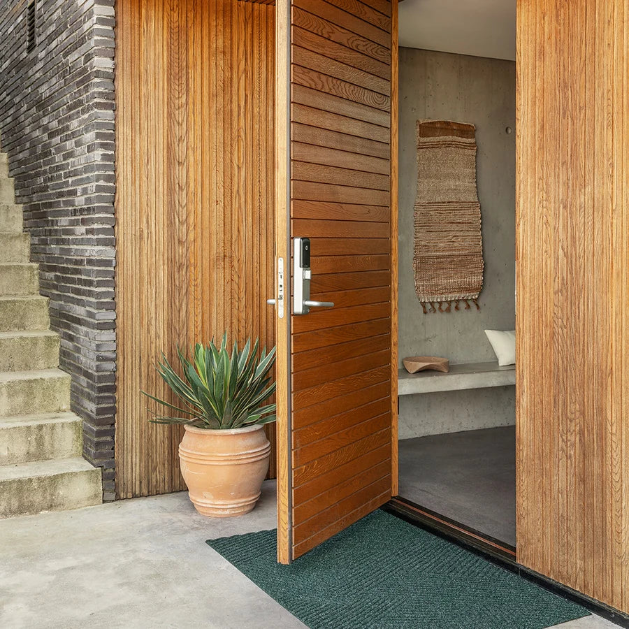 Heymat Strå All Weather Doormat doormat in Green styled in an entryway, recycled PET yarn Norwegian design