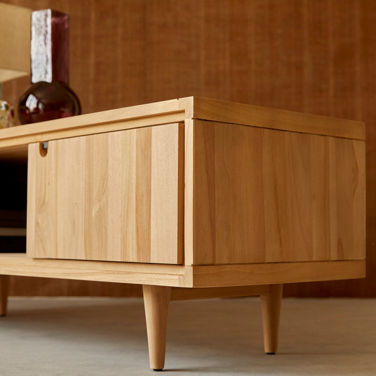 Tikamoon Jonak teak TV stand, detail of the open niche and sloping leg