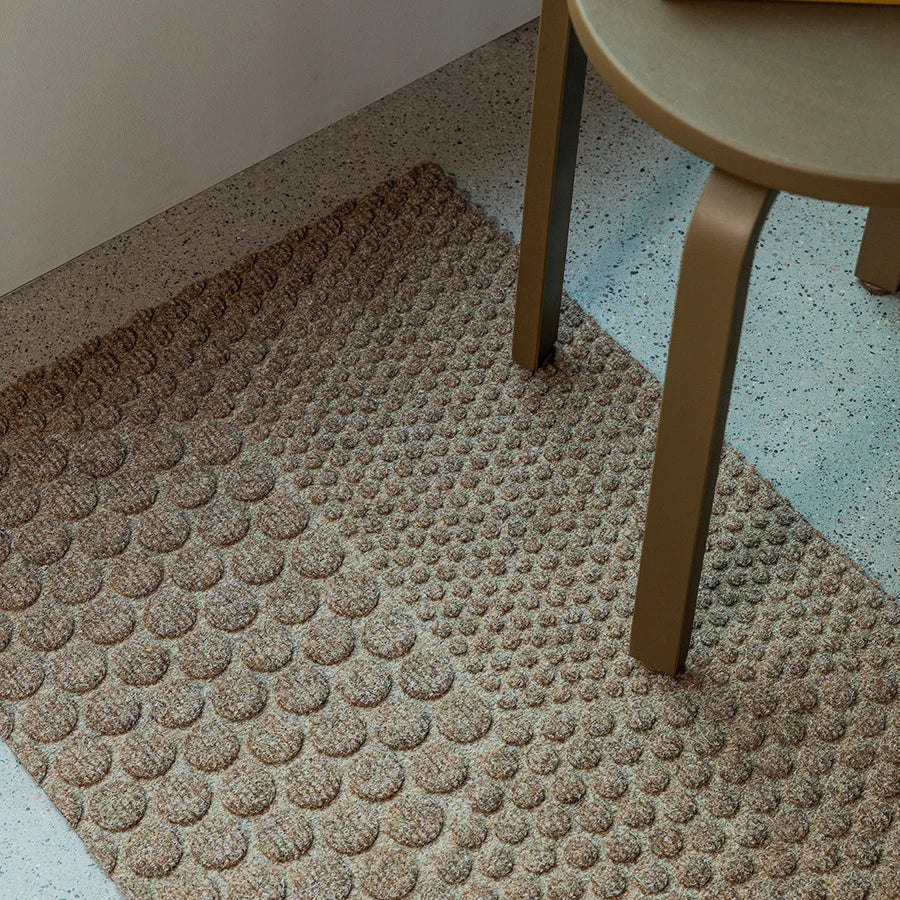 Heymat Hex All Weather Doormat doormat in Desert Beige styled in an entryway, recycled PET yarn Norwegian design