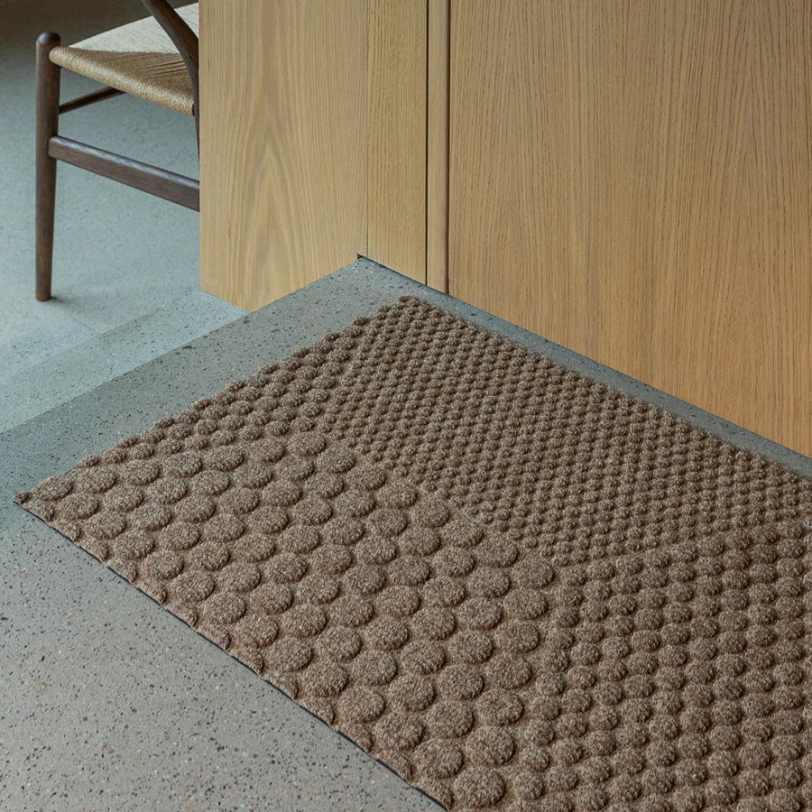 Heymat Hex All Weather Doormat doormat in Desert Beige styled in an entryway, recycled PET yarn Norwegian design