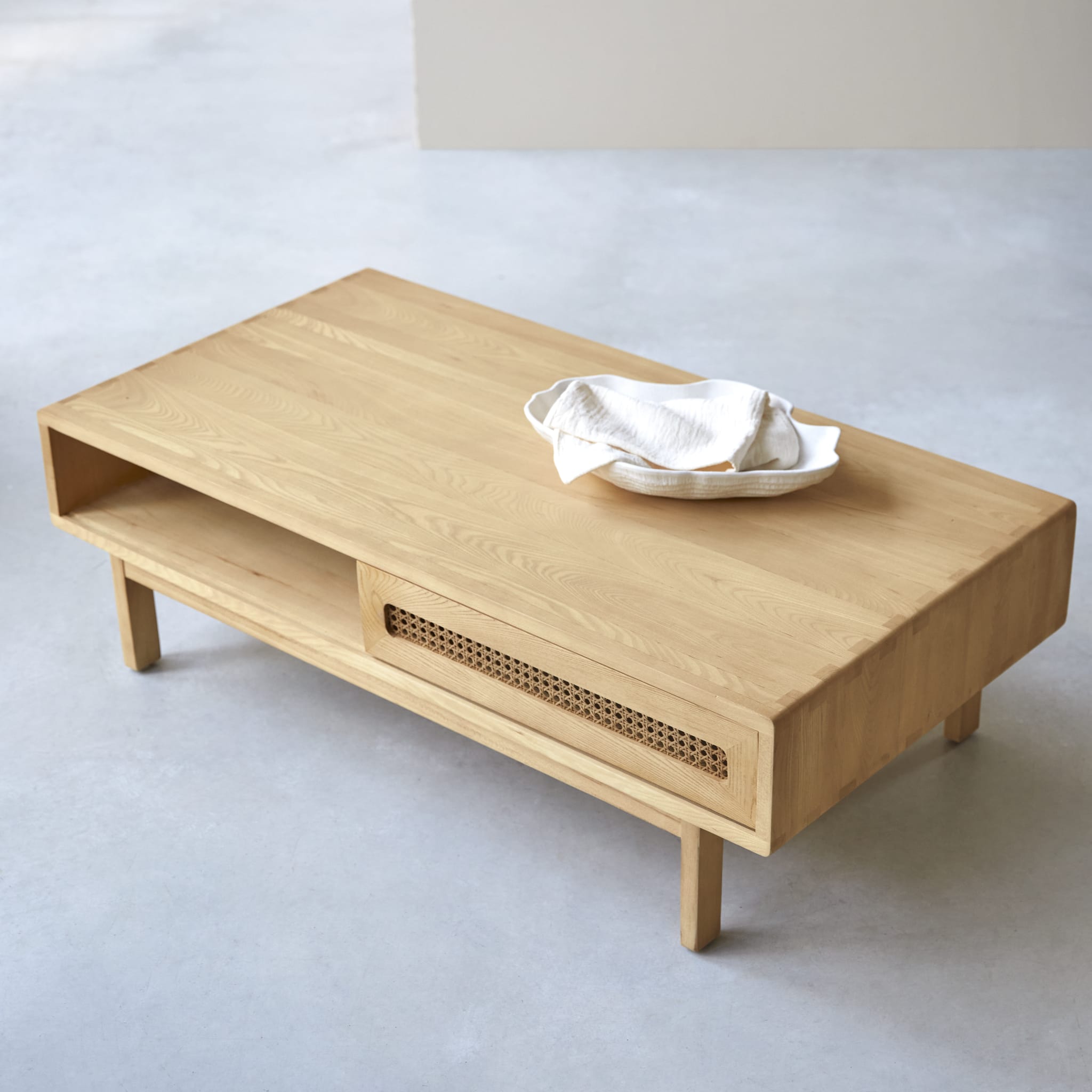 Tikamoon Luis coffee table in solid elm with canework detailing, angled view