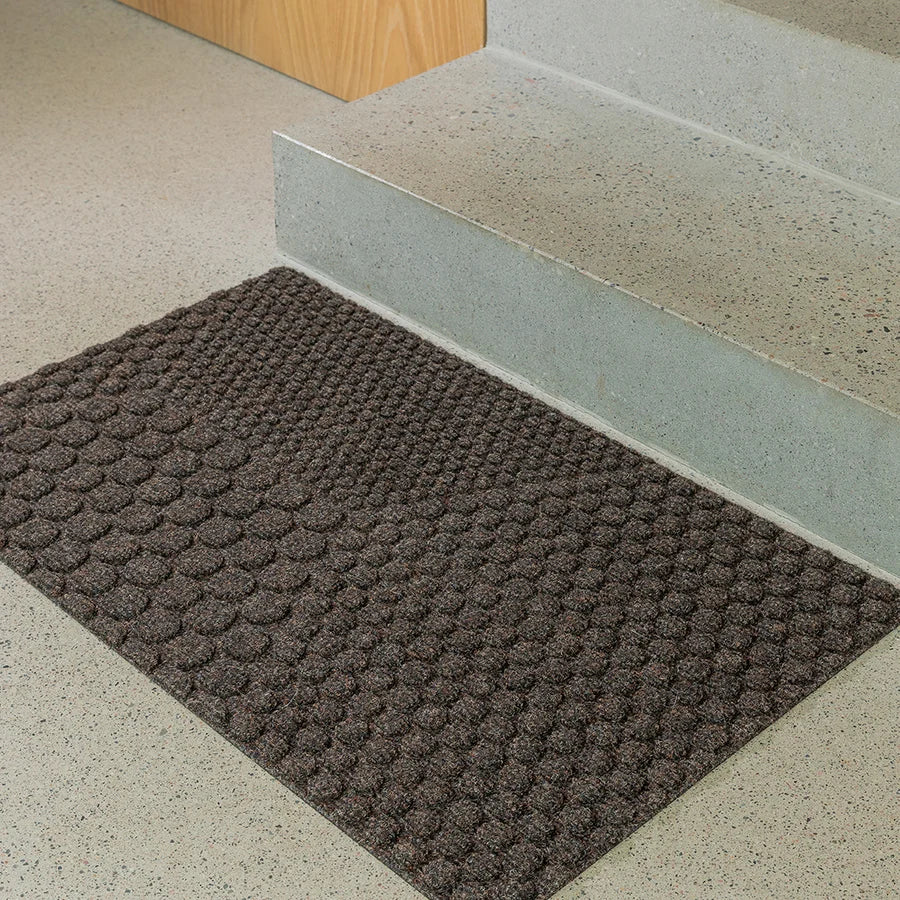 Heymat Hex All Weather Doormat doormat in Soil Brown styled in an entryway, recycled PET yarn Norwegian design