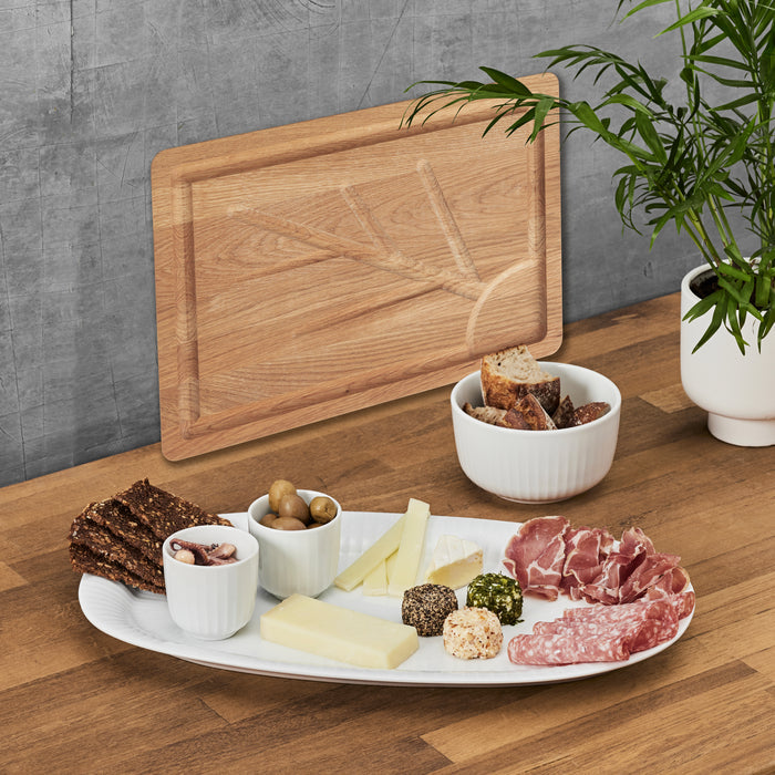 Kähler Hammershøi Serveware by Hans-Christian Bauer, styled on a dining table, B Corp certified Danish ceramic since 1839.