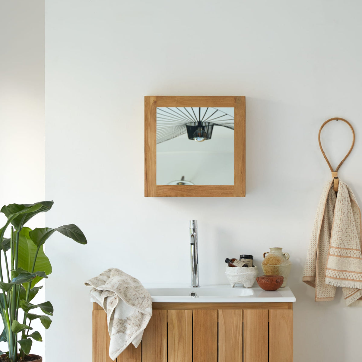 Tikamoon Jill teak mirrored cabinet above a bathroom vanity