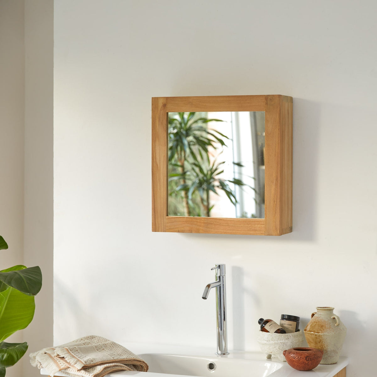 Tikamoon Jill teak mirrored cabinet above a white basin