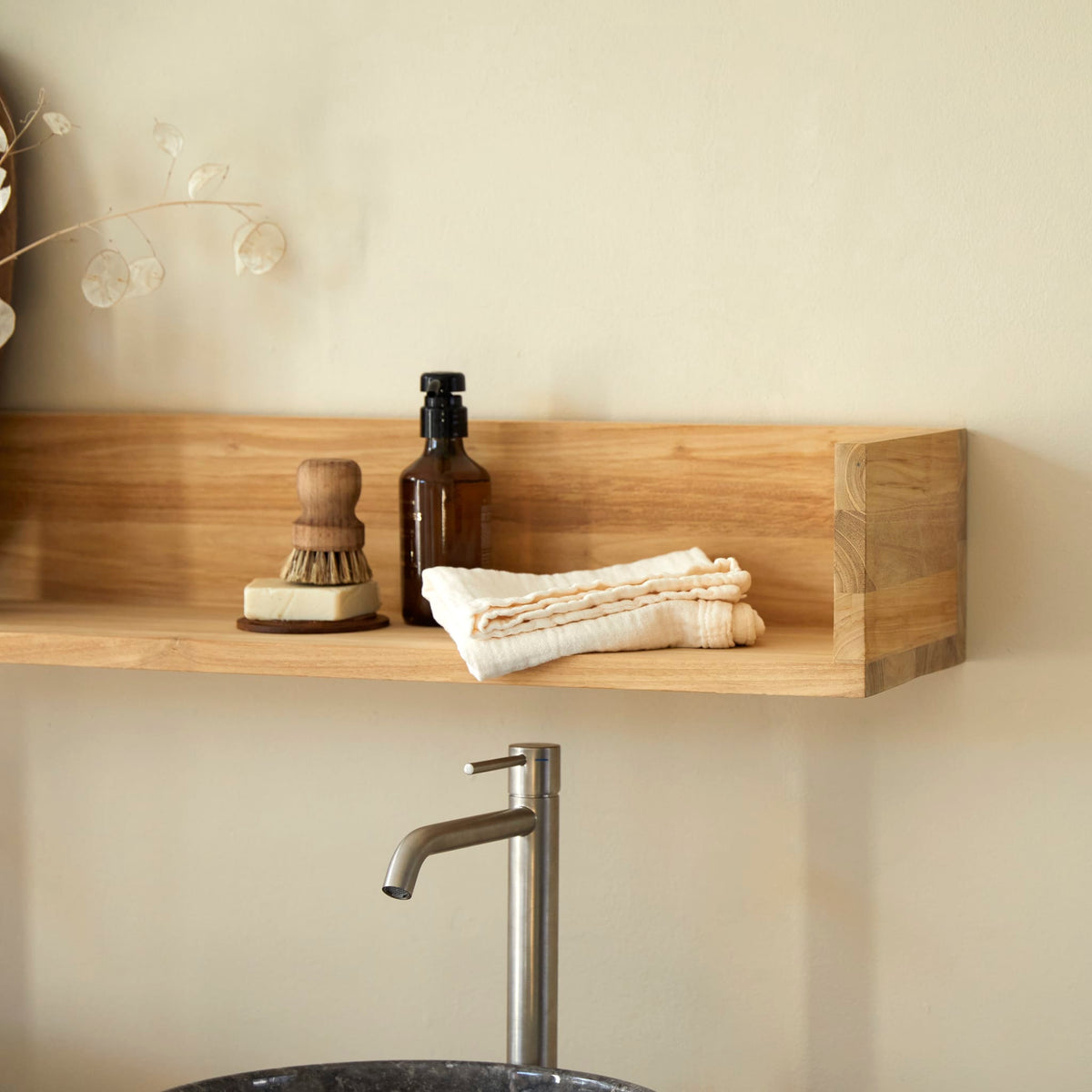 Tikamoon Arty teak wall shelf with a soap bottle, brush and towel