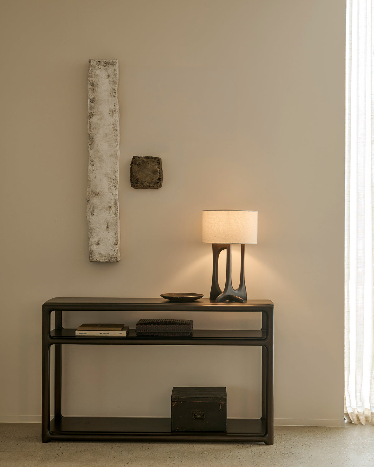 Ethnicraft Eda Console in Rose Brown with Flow table lamp, styled in an entryway, solid mahogany