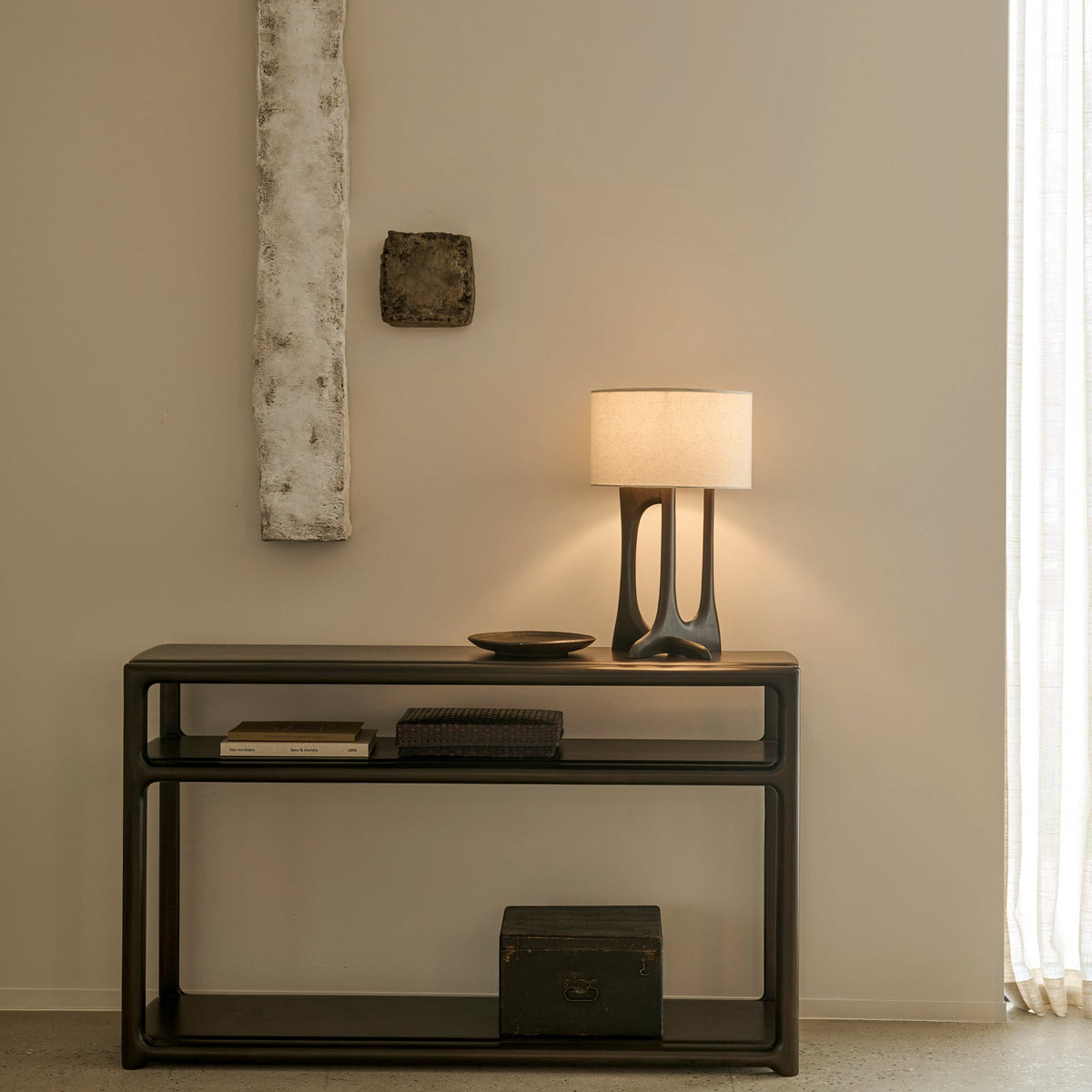 Ethnicraft Eda Console in Rose Brown with Flow table lamp, styled in an entryway, solid mahogany