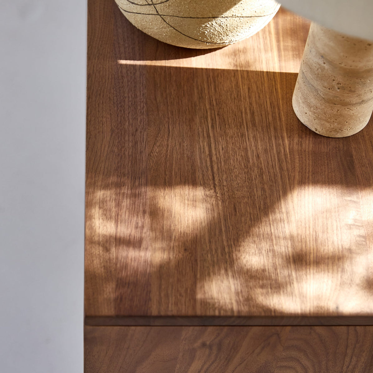 Tikamoon Esmée TV stand in solid walnut, three-quarter view