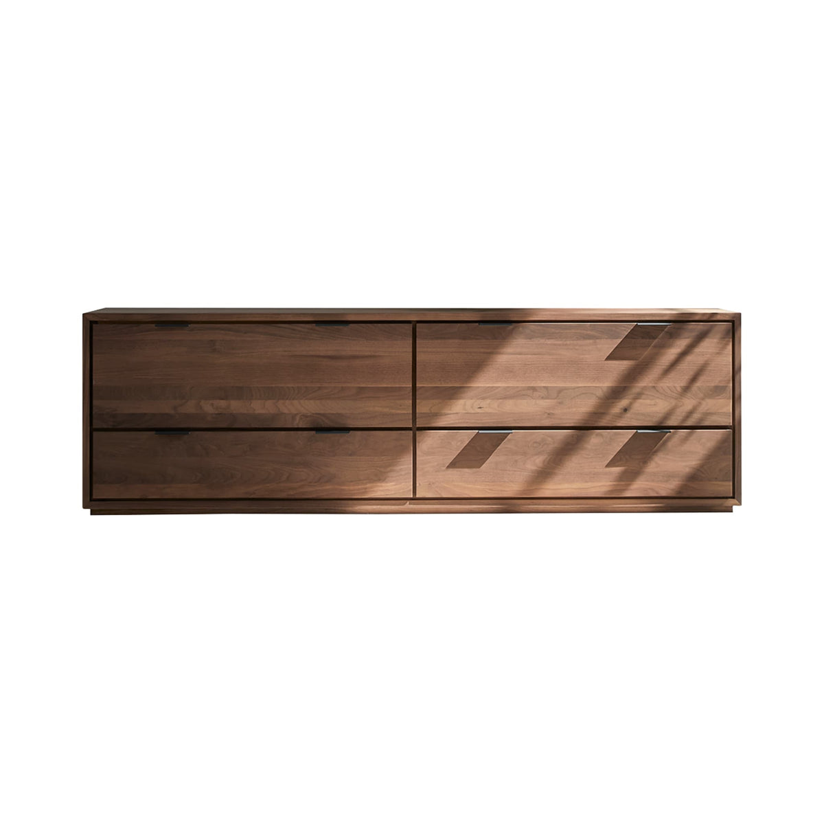 Tikamoon Senson TV stand in solid walnut, styled against a living room wall