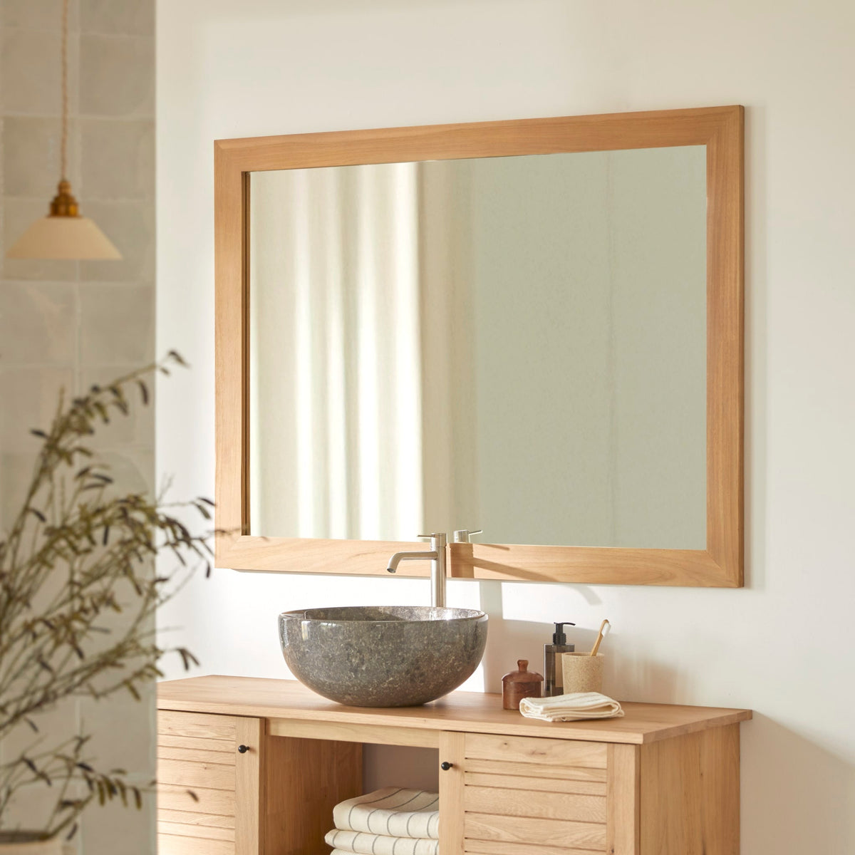 Tona solid teak mirror, front view on a white wall