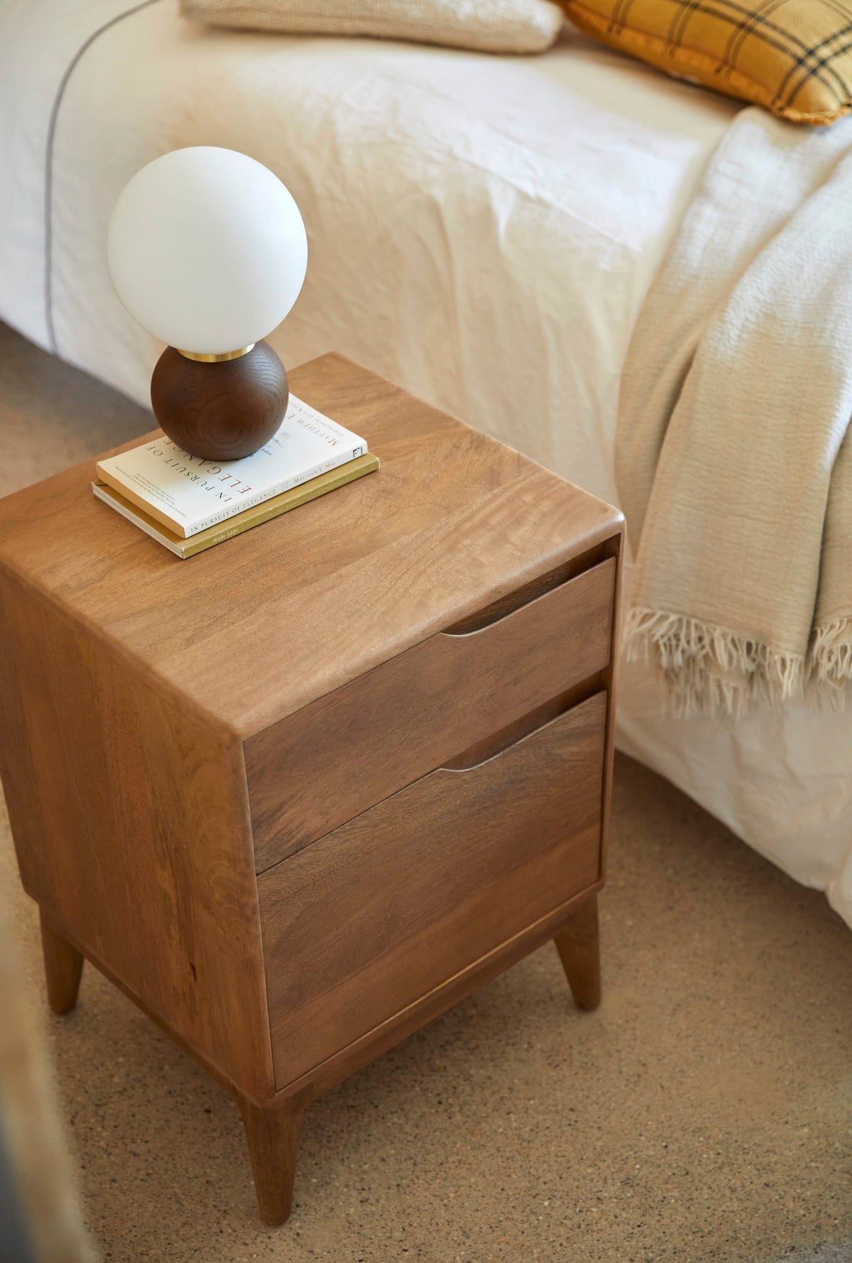 Tikamoon Gabrielle bedside table in solid mango, detail of the lower drawer front
