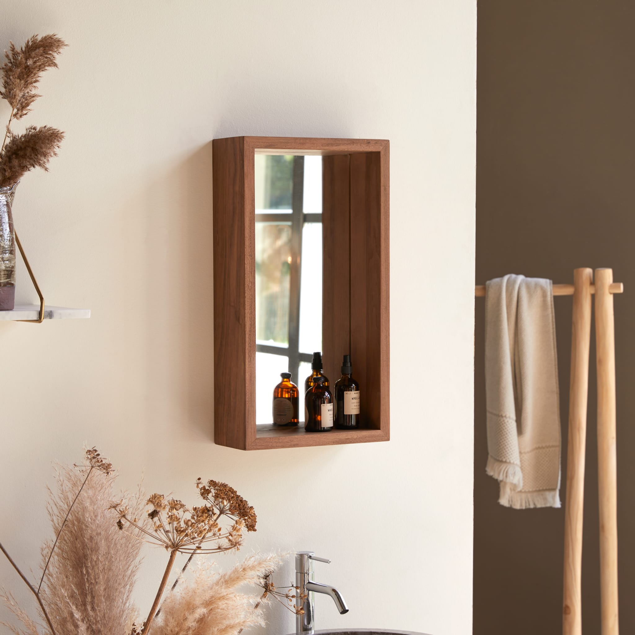 Stelle mirror, angled view showing the deep walnut frame