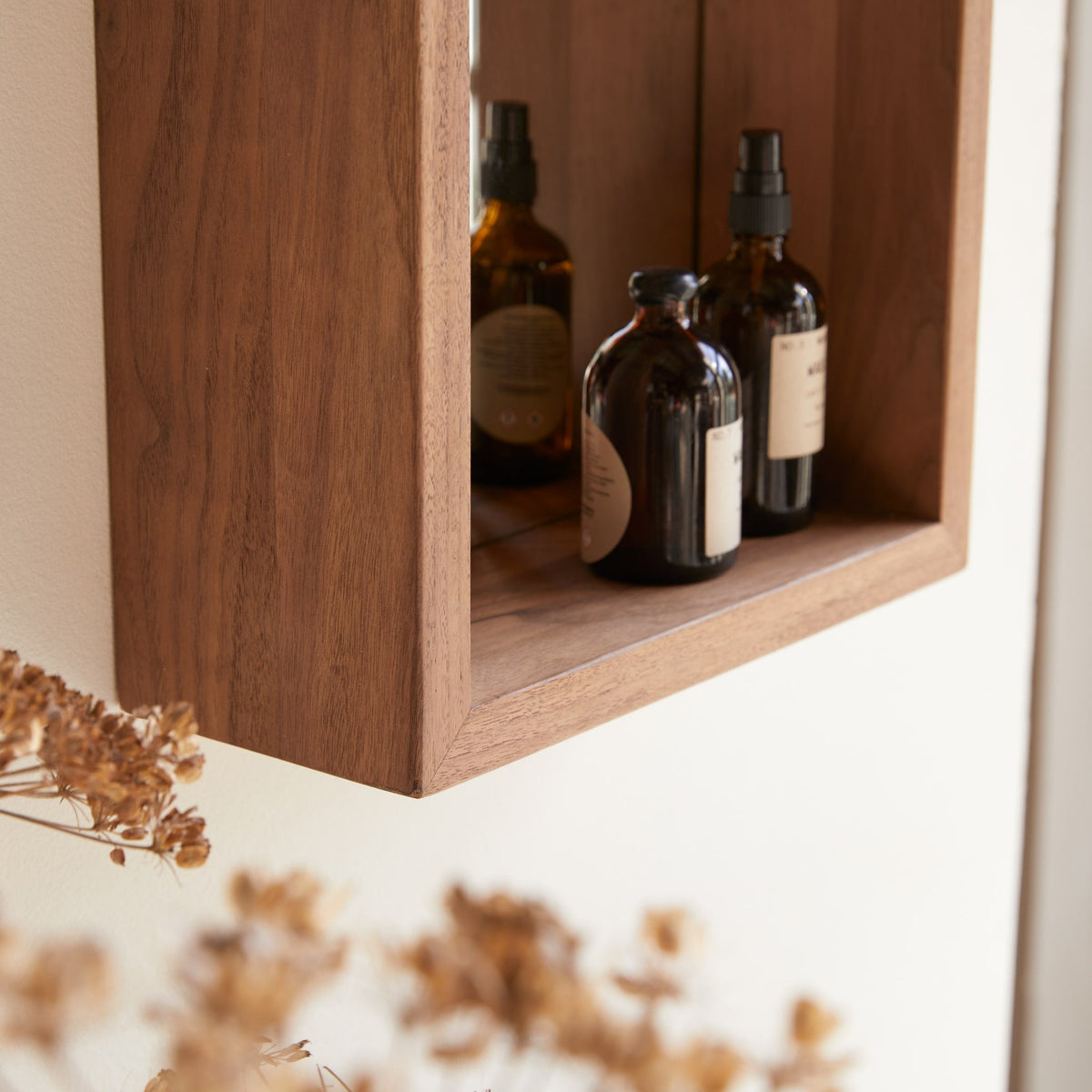 Stelle walnut mirror hung vertically above a bathroom vanity