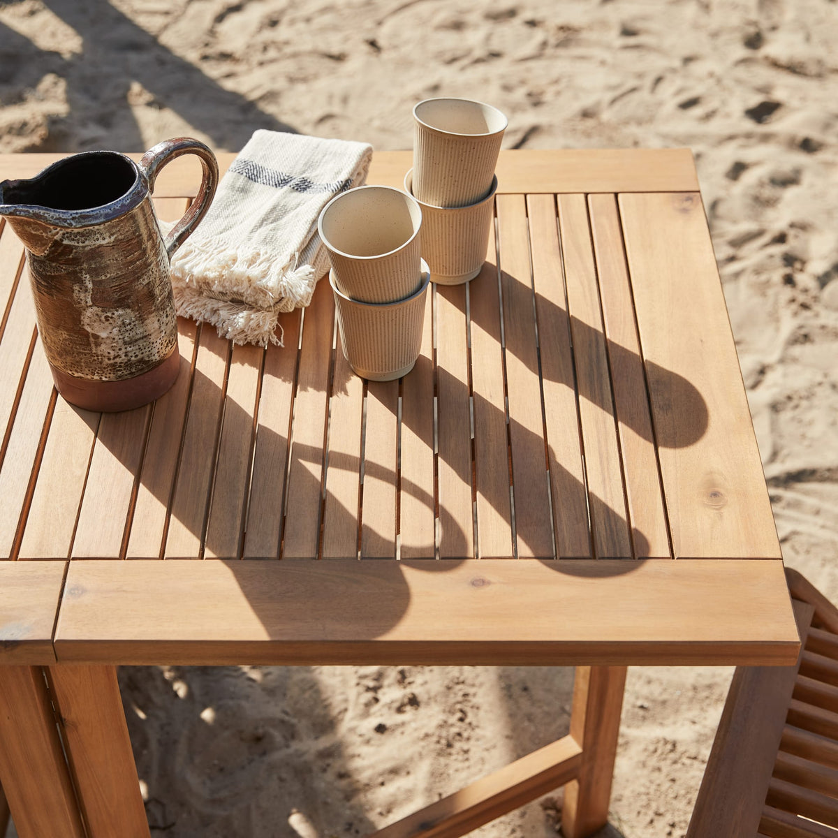 Tikamoon Capri folding garden table in solid acacia, side profile