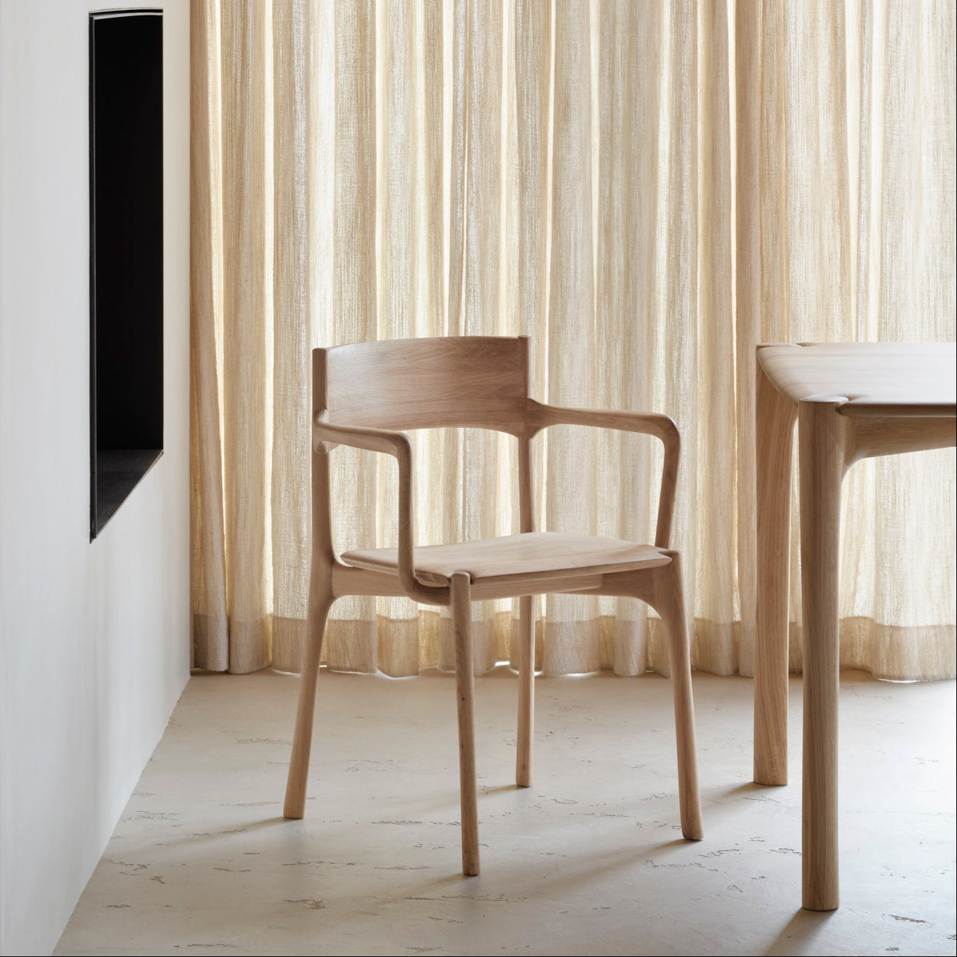 Ethnicraft Pi Dining Chair in oak styled in a dining room