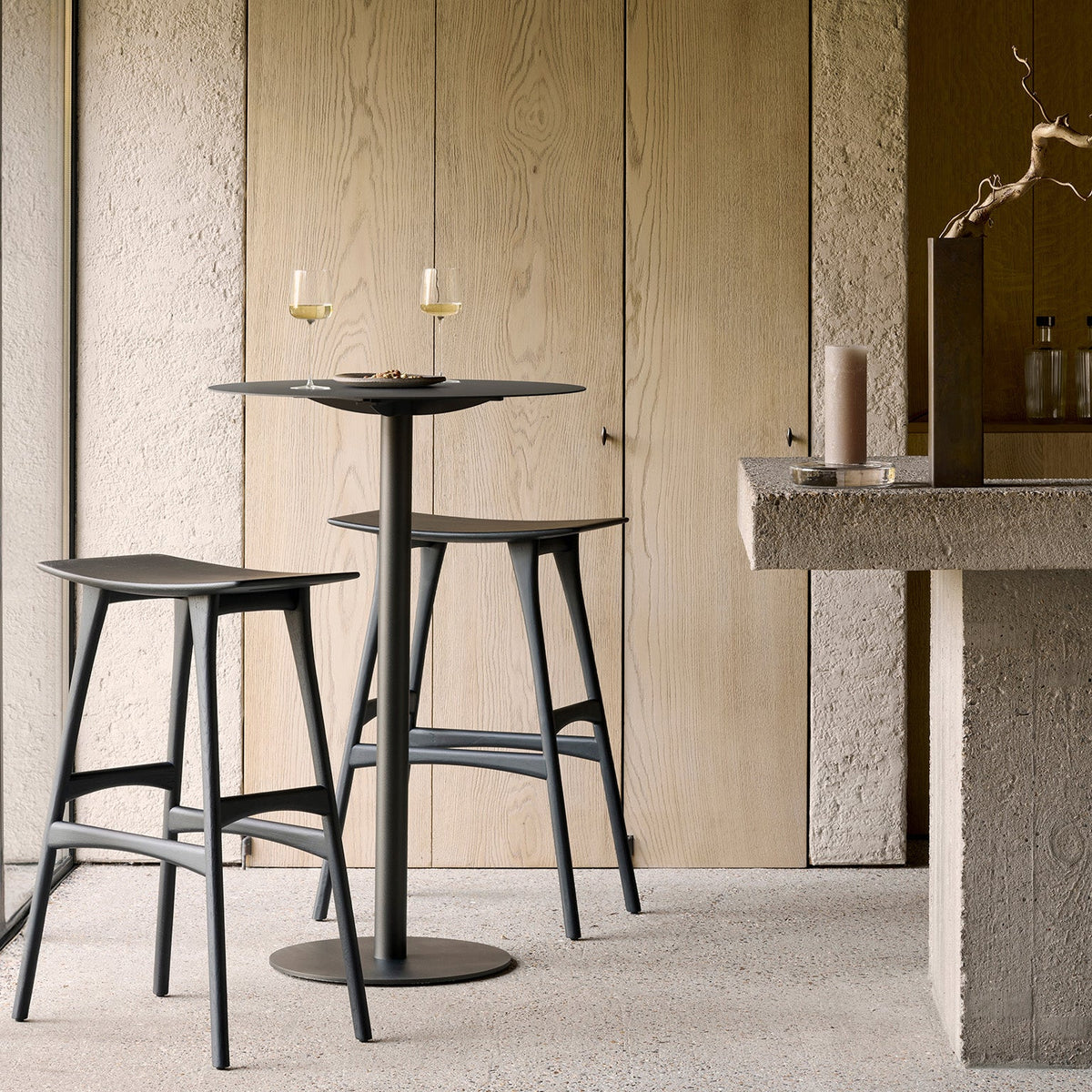 Ethnicraft Blend Bar Table in Dark Bronze Metal, styled with bar stools, powder-coated metal