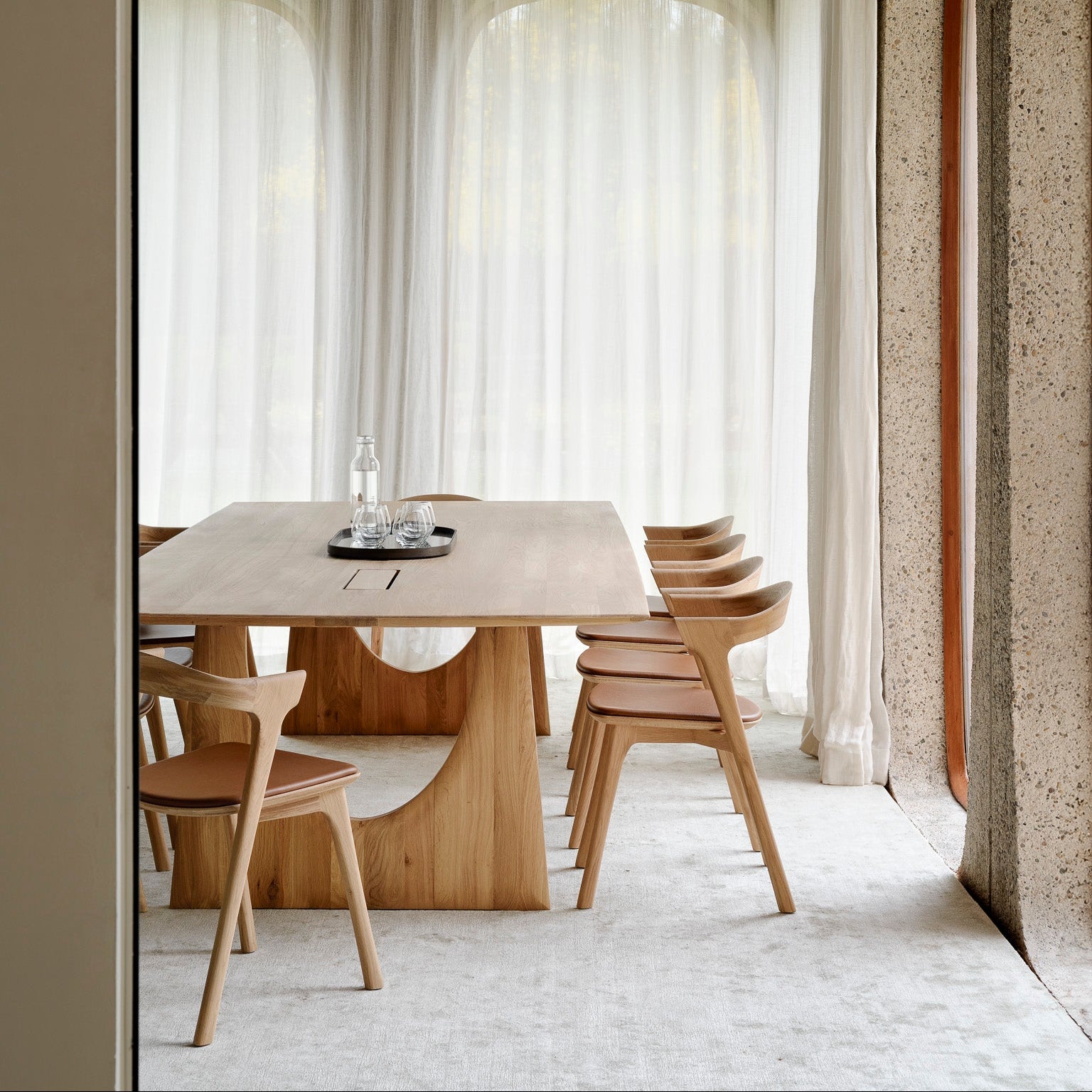 Ethnicraft Geometric Meeting Table in oak styled in a dining room