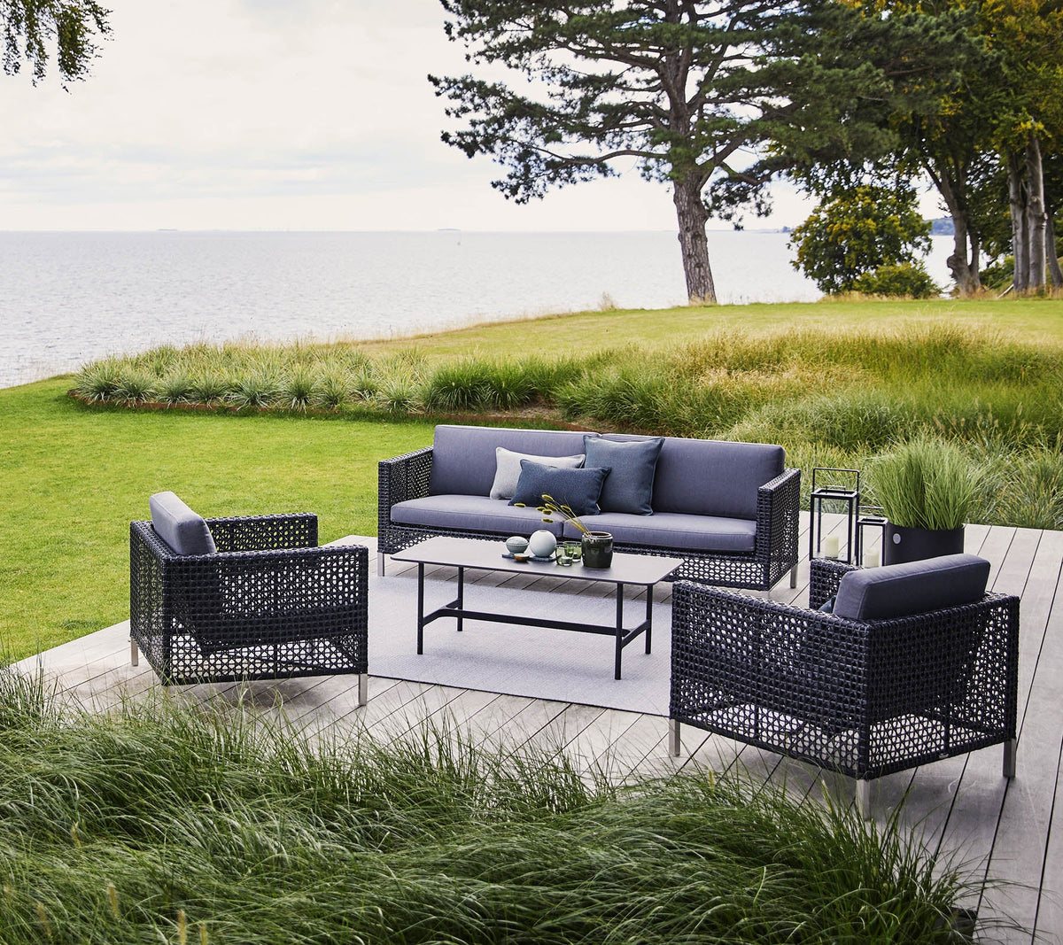 Cane-line Connect Lounge Chairs in Black/Graphite with a Connect sofa, styled on a terrace, polyethylene Weave