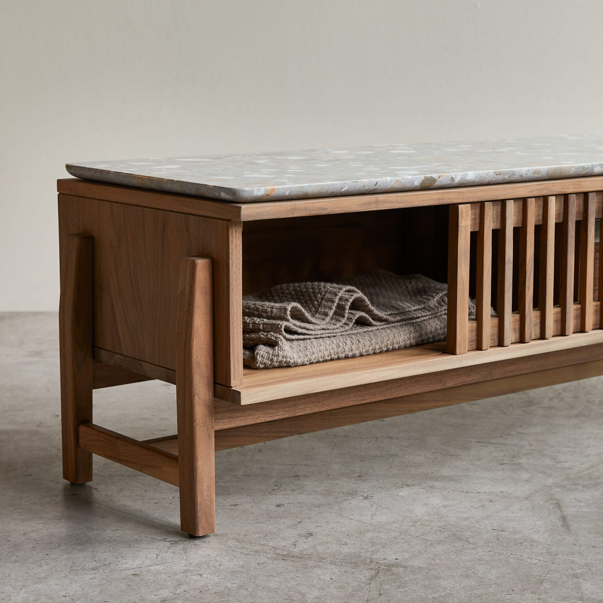 Tikamoon Isaure TV stand in solid walnut with a terrazzo top, close-up of the clear-view door
