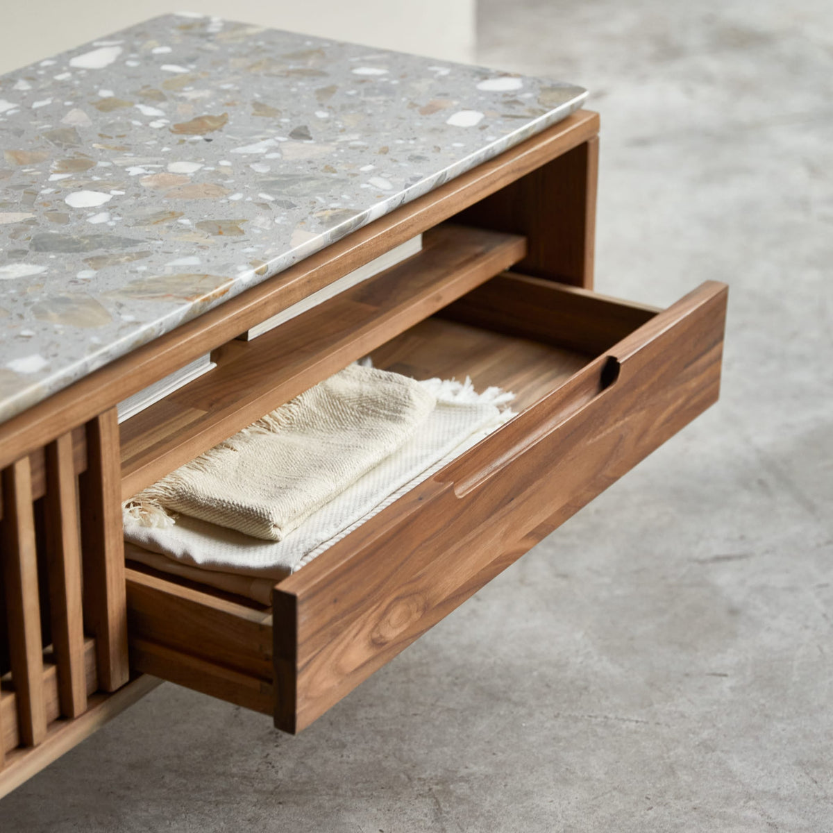 Tikamoon Isaure TV stand in solid walnut with a terrazzo top, detail of the terrazzo surface