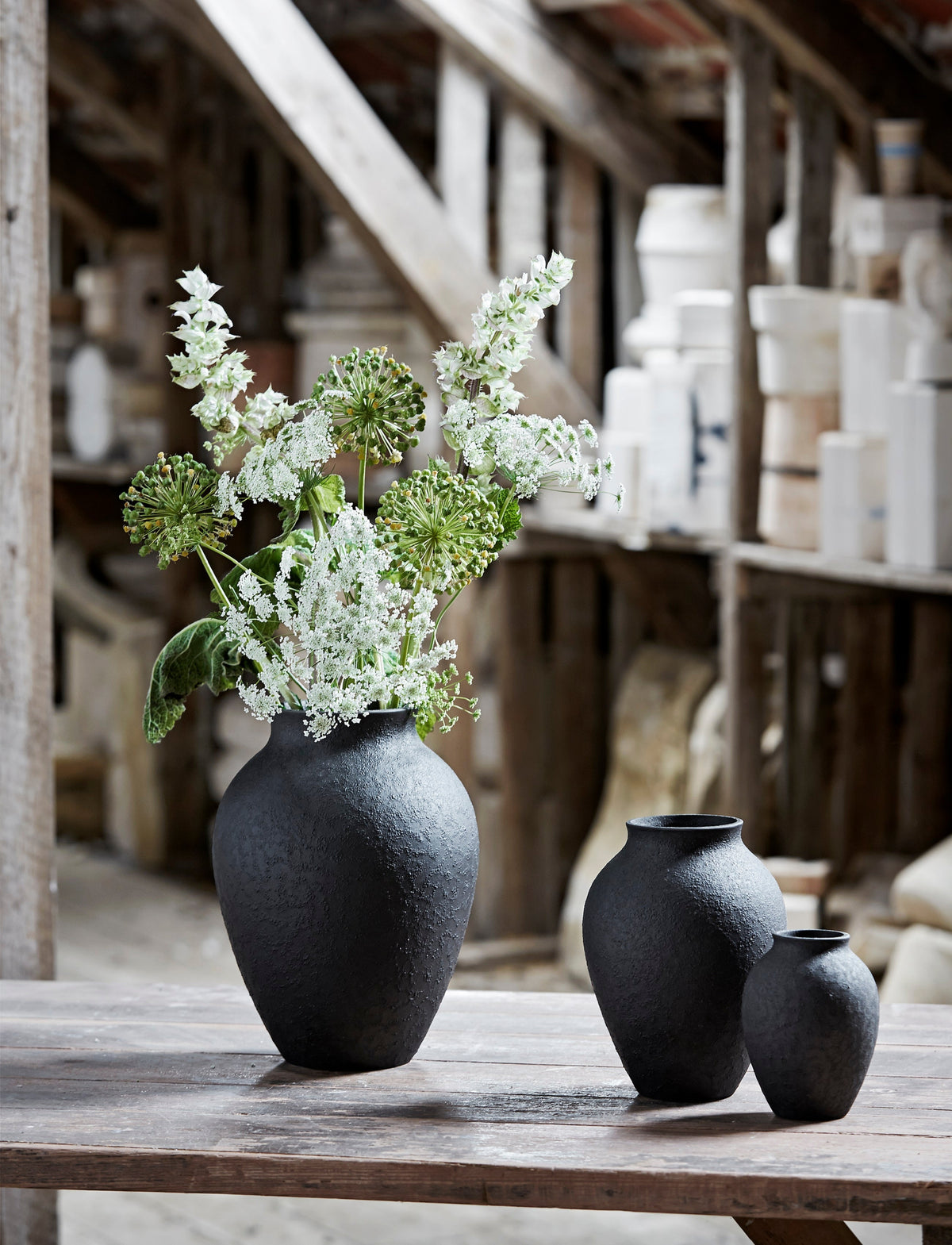 Knabstrup Vase in black, styled in an interior setting, glazed earthenware