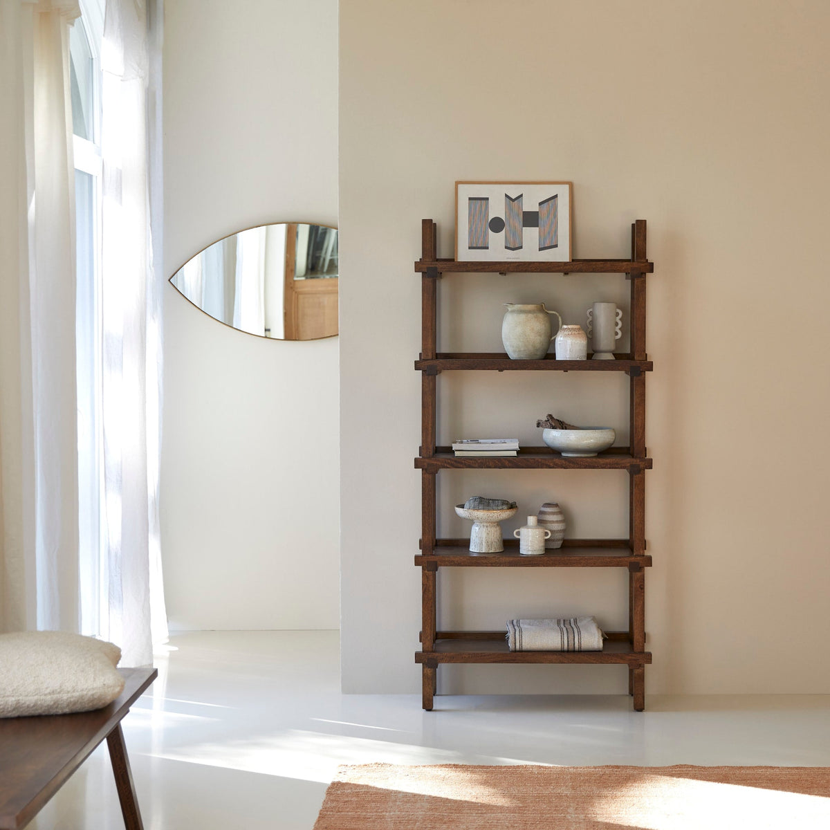 Tikamoon Arko tall bookcase in solid mango wood, angled view