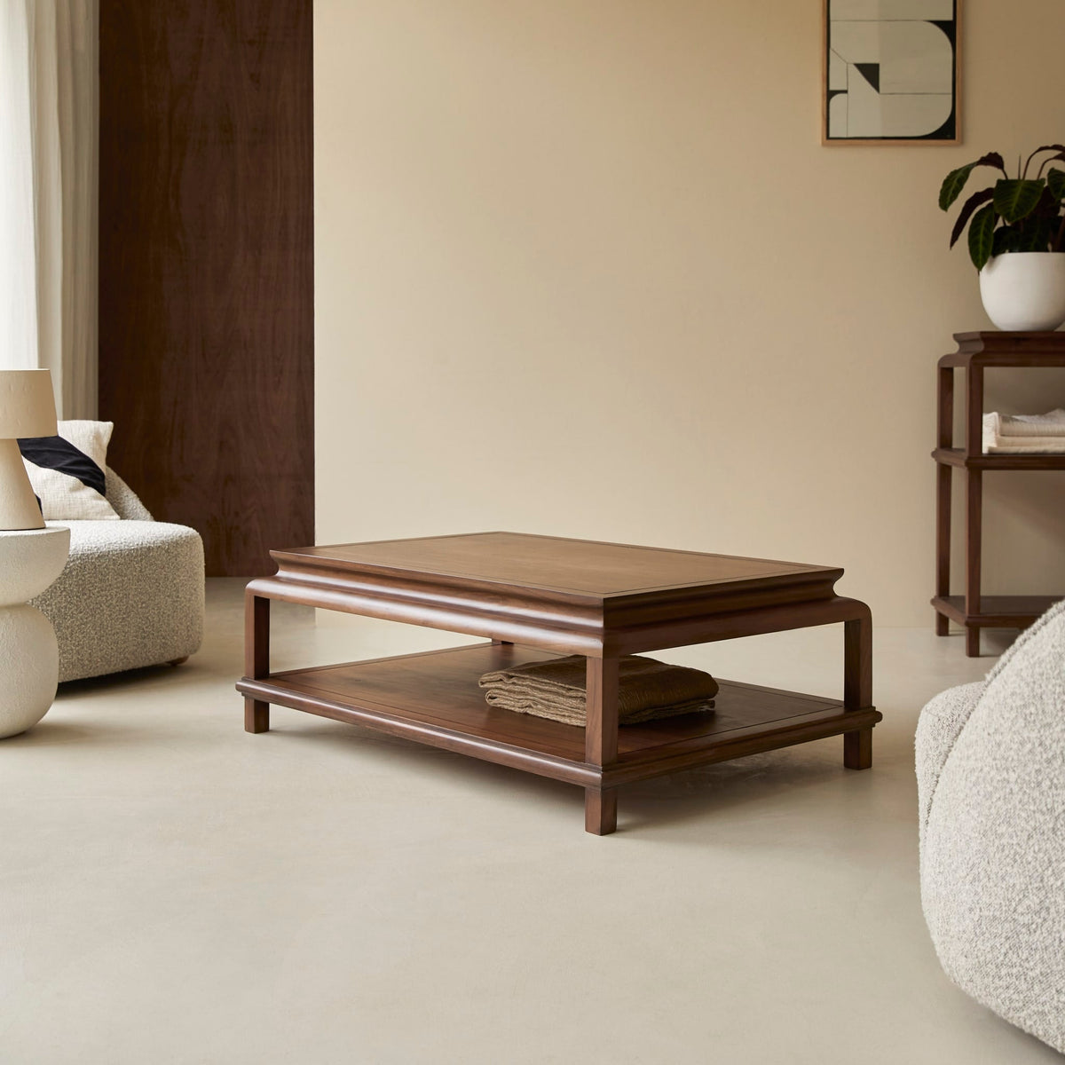 Tikamoon Achille acacia coffee table beside a boucle sofa