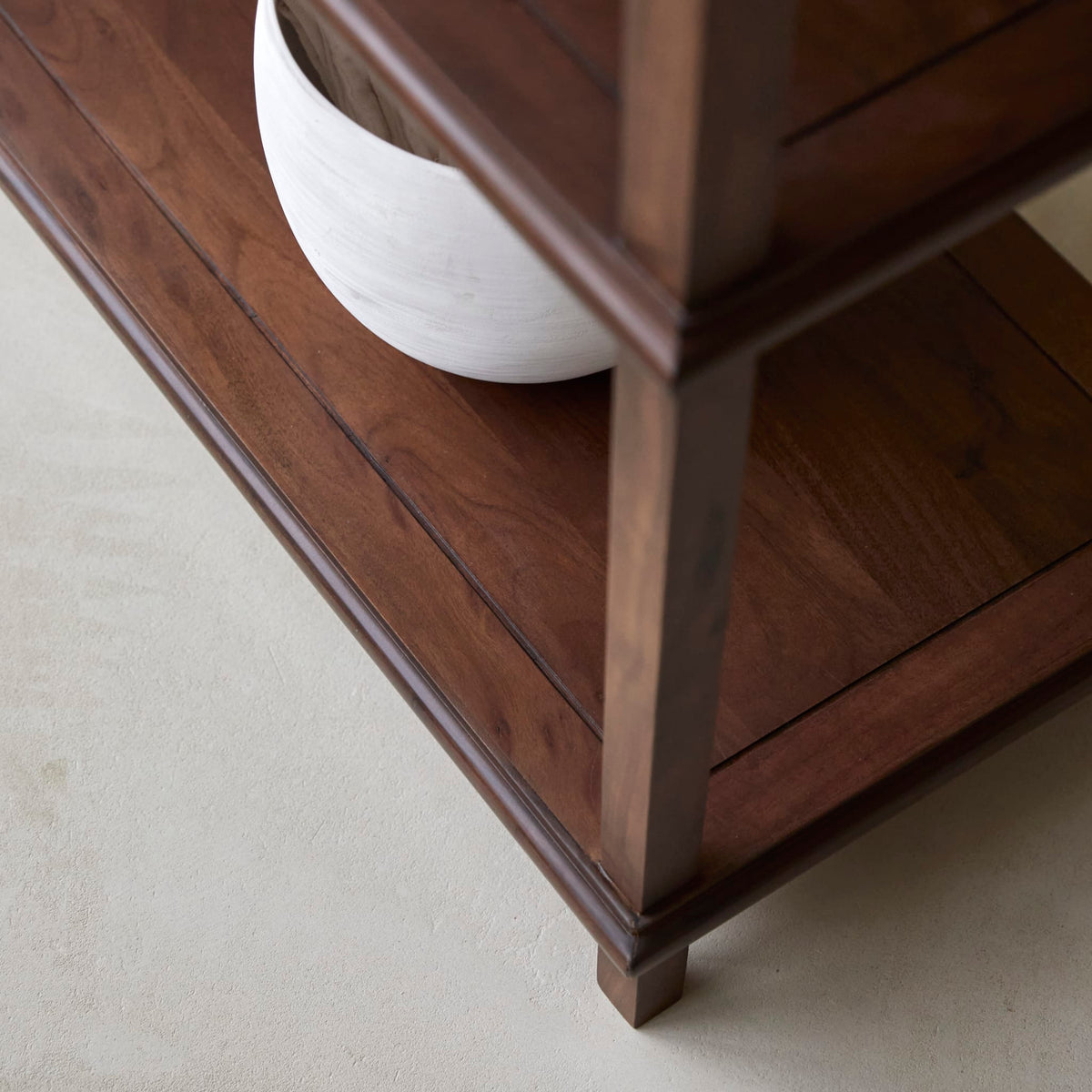 Detail of the Achille console lower shelf corner