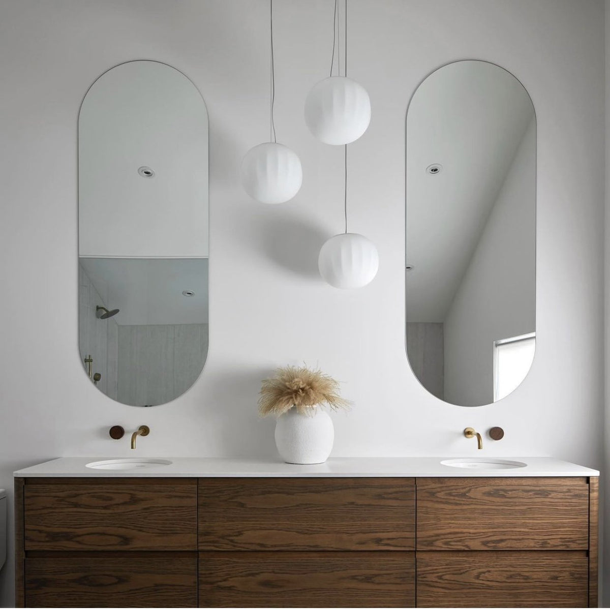 Luceplan Lita Pendants over a bathroom vanity