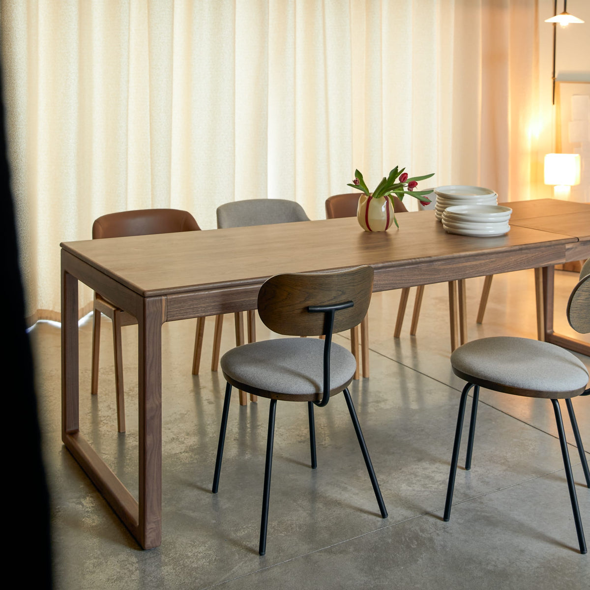 Tikamoon Arto extendable dining table in solid walnut, three-quarter view of the top