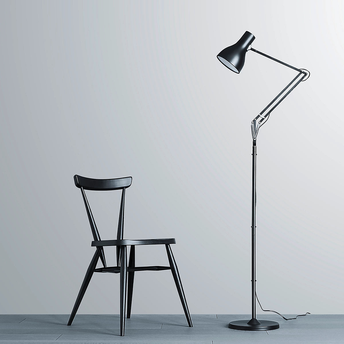 Anglepoise Type 75 floor lamp in black beside a black wooden chair