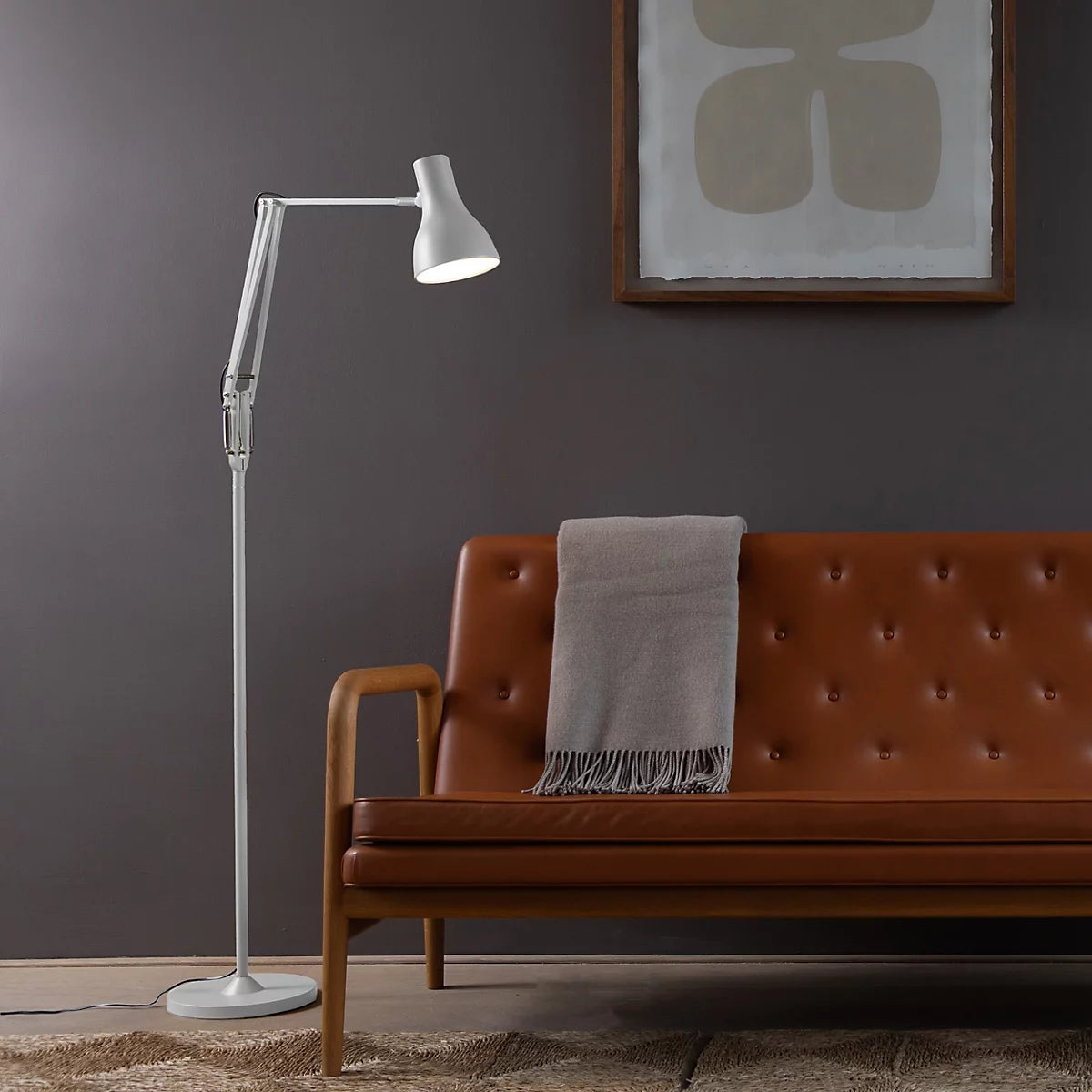 Anglepoise Type 75 floor lamp in white beside a brown leather sofa