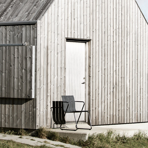 Mater Ocean Chair styled in an outdoor setting, slats of recycled plastic waste