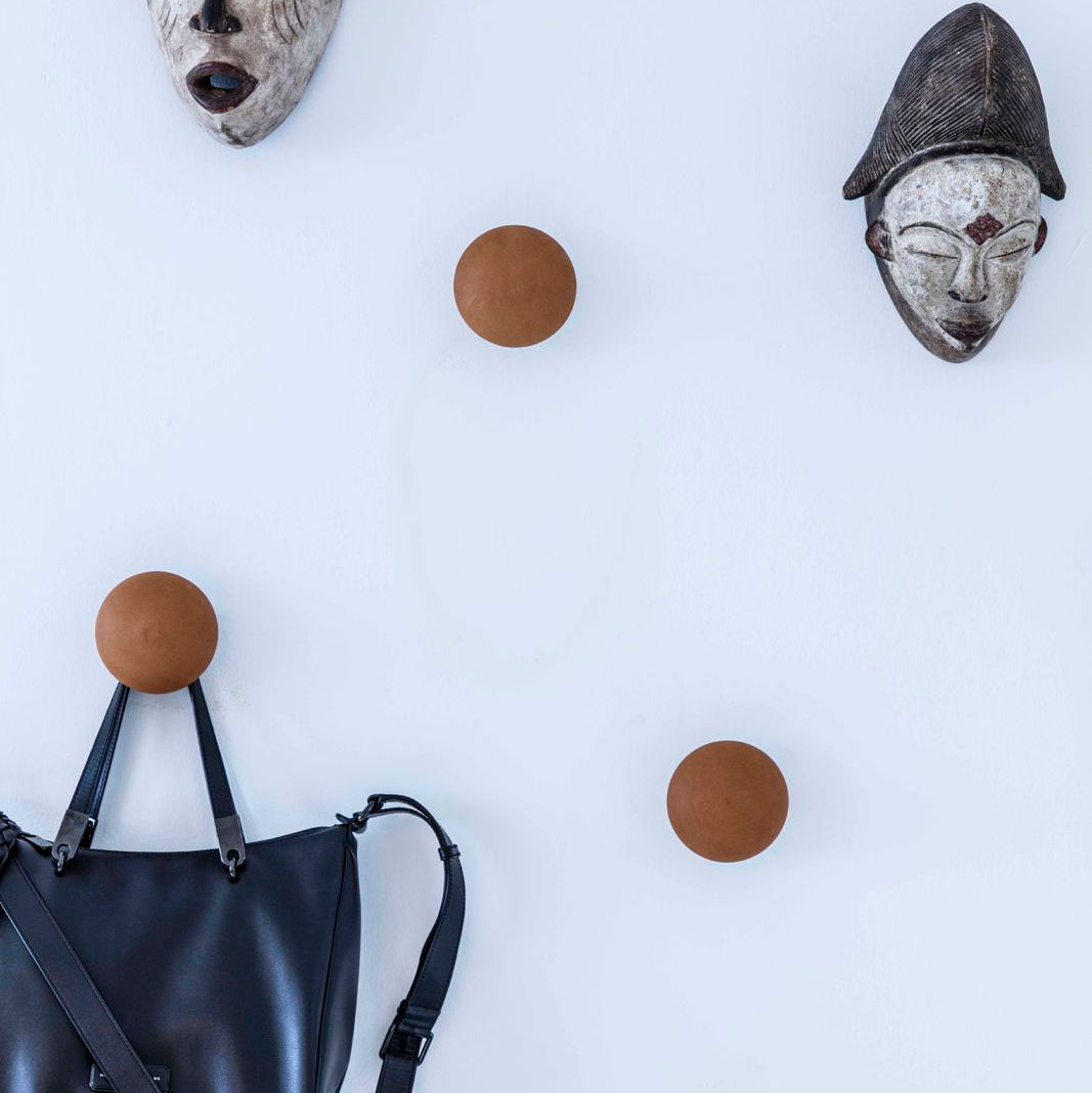 Bent Hansen Button-Up Wall Hook in cognac leather, styled in an interior setting, leather