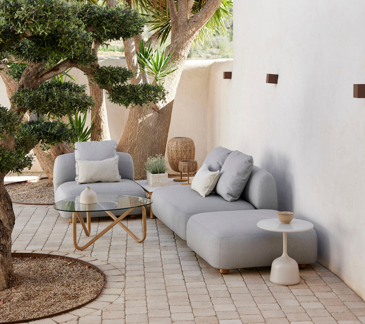 Cane-line Capture modules in light grey AirTouch acrylic, styled on a terrace with a side table
