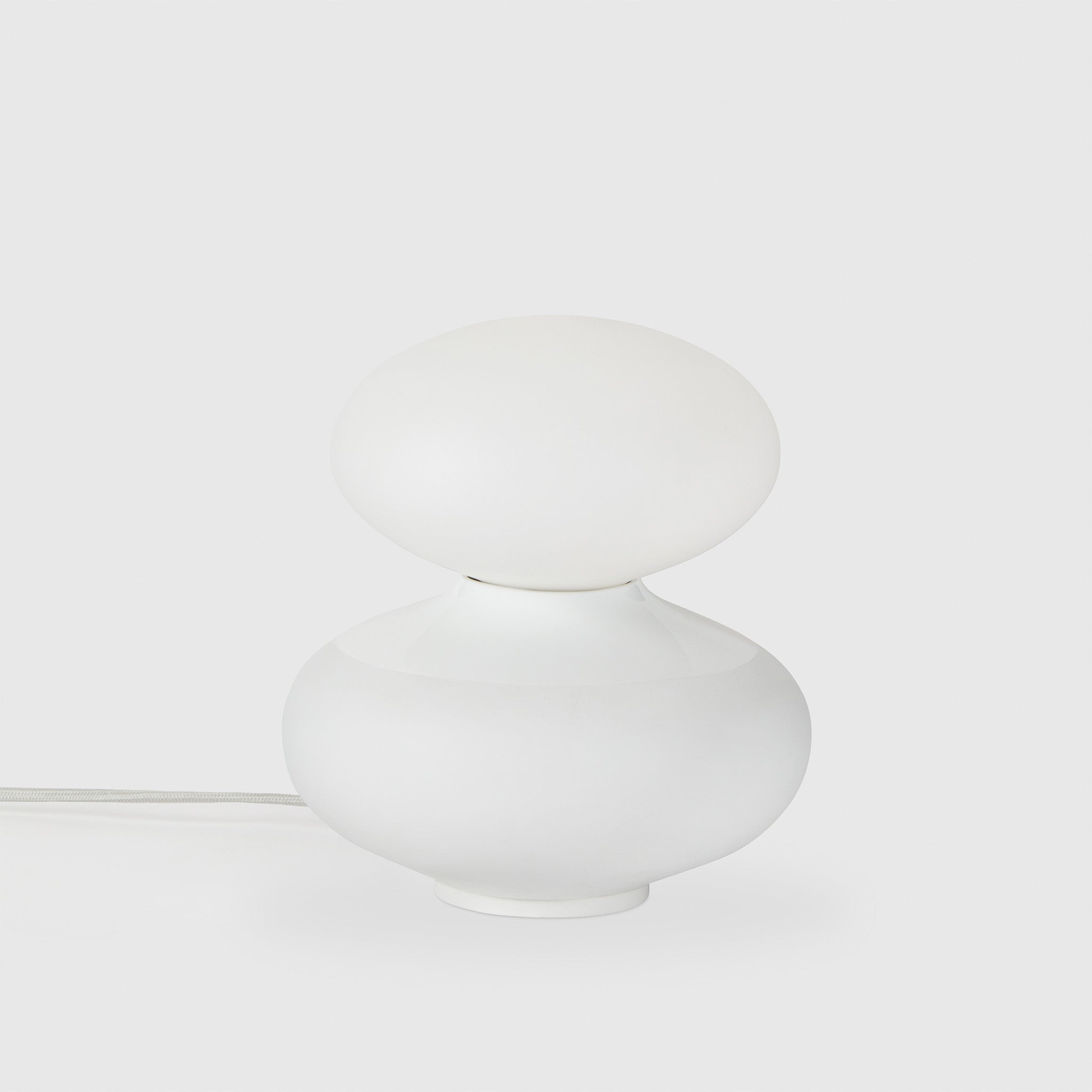 Tala Reflection Oval Table Lamp, off, on grey background