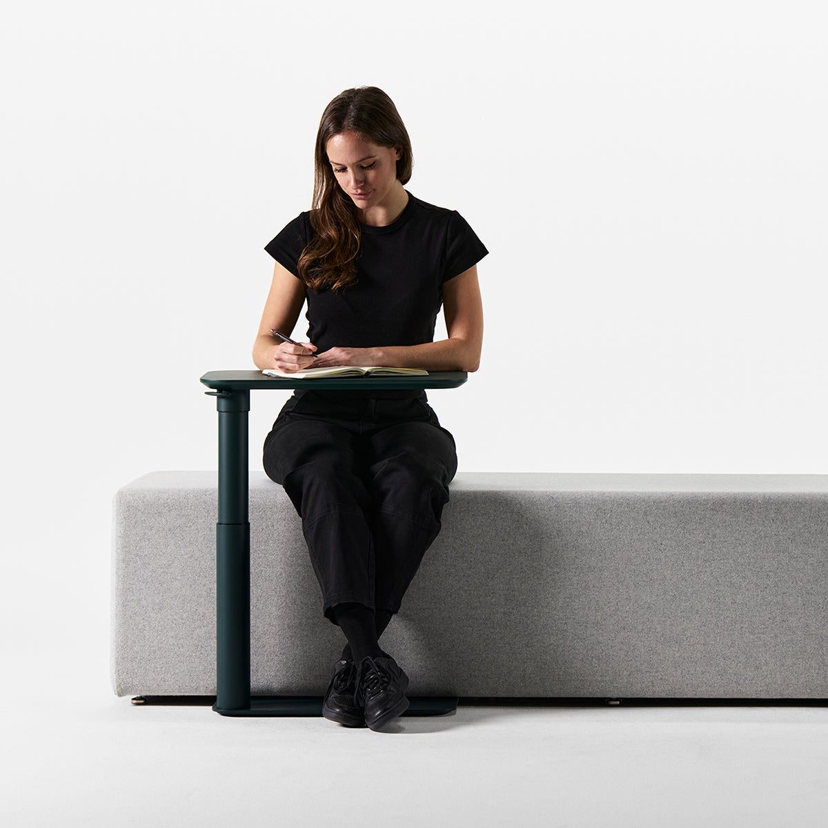 Humanscale Float Micro standing desk styled in a workspace, B Corp climate-positive office design