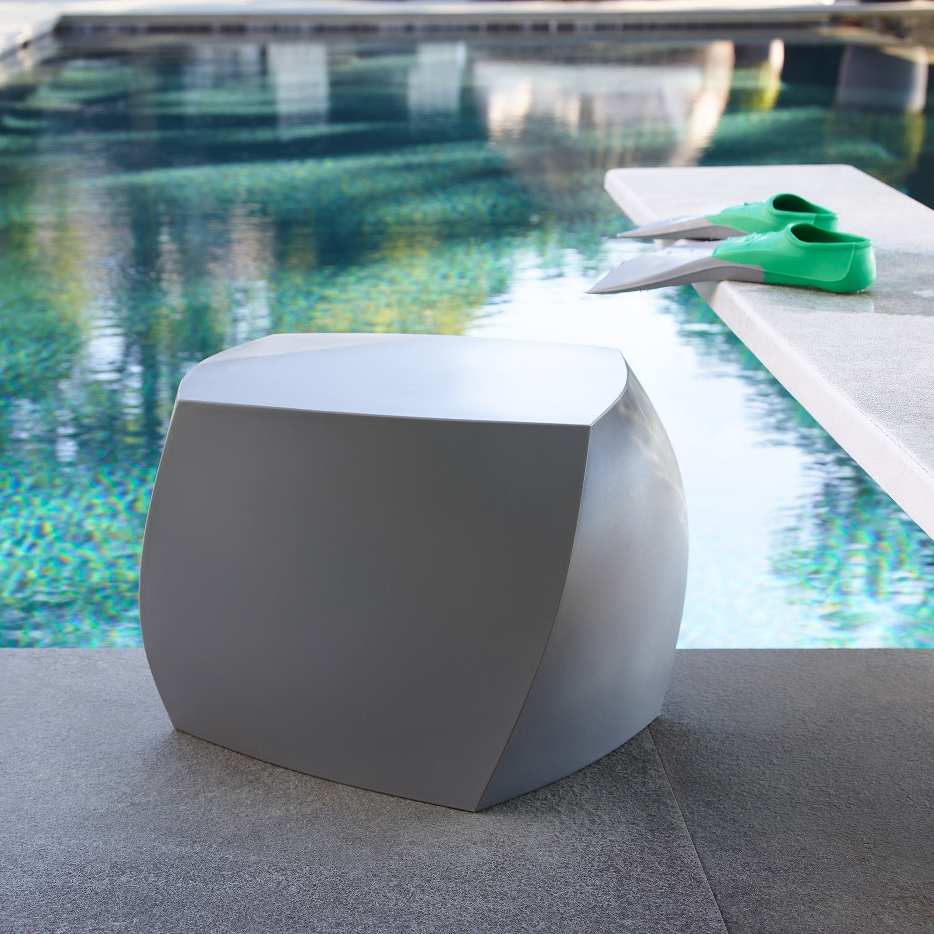 Modern gray outdoor stool by a pool