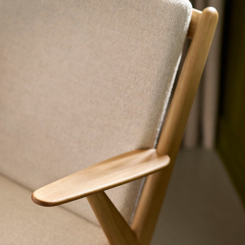 FDB Møbler Armchair in solid oak (beige), designed by Poul M. Volther