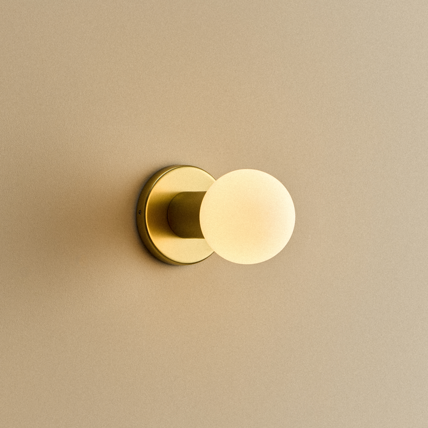 Lochan Wall Light in Brass with Sphere III bulb, illuminated