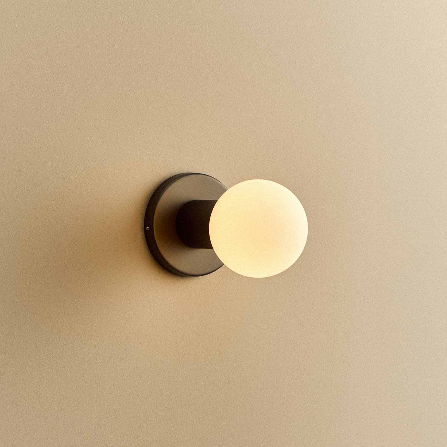 Lochan Wall Light in Graphite with Sphere III bulb, illuminated